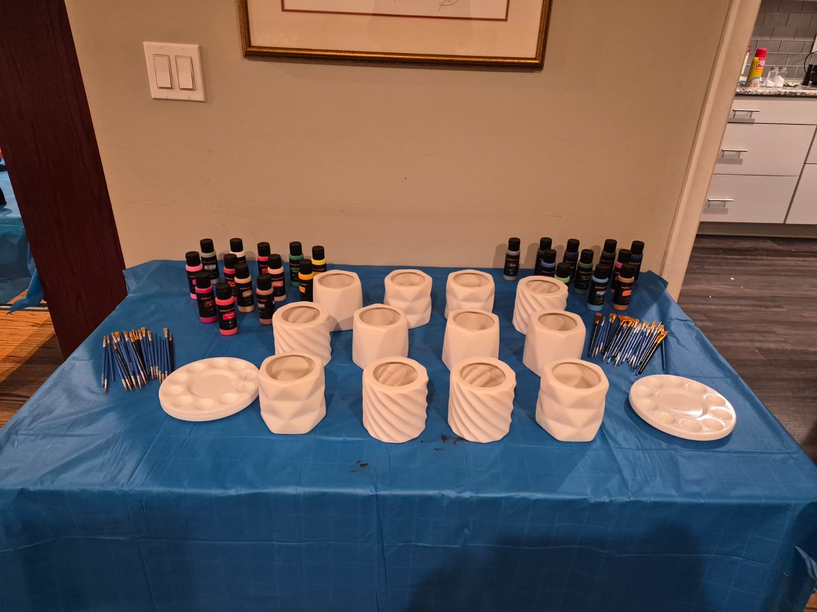 Ceramic pots and paints set out for a club craft activity