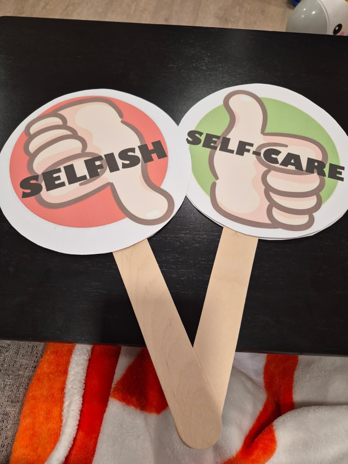 Selfish versus self-care answer paddles used for a club discussion activity